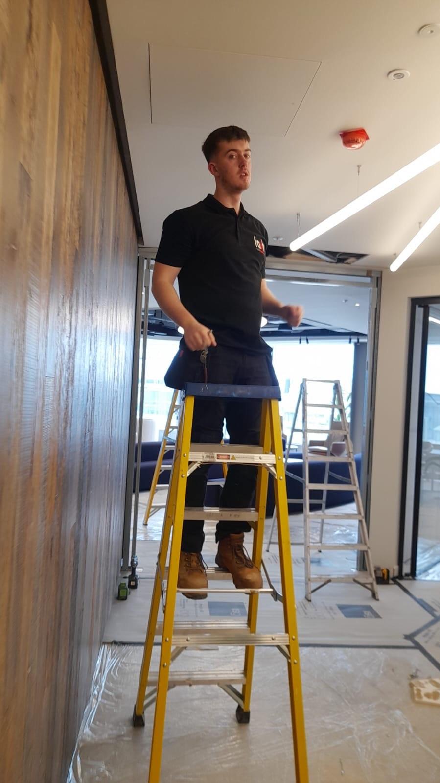 Faith Systems engineer installing fire alarm